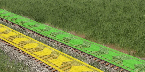 Green and yellow directional route arrows on parallel railway tracks